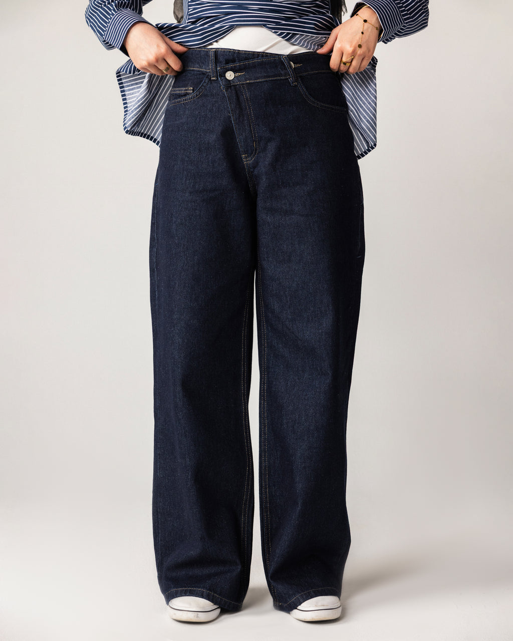High-waist jeans asymmetric front zip and metal button fastening