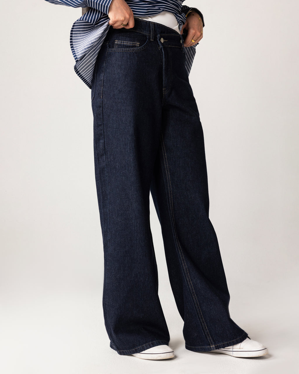 High-waist jeans asymmetric front zip and metal button fastening